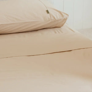 Sand pillowcases on queen bed with sand queen flat sheet from the 4th corner.