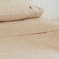 Sand pillowcases on queen bed with sand queen flat sheet from the 4th corner. 