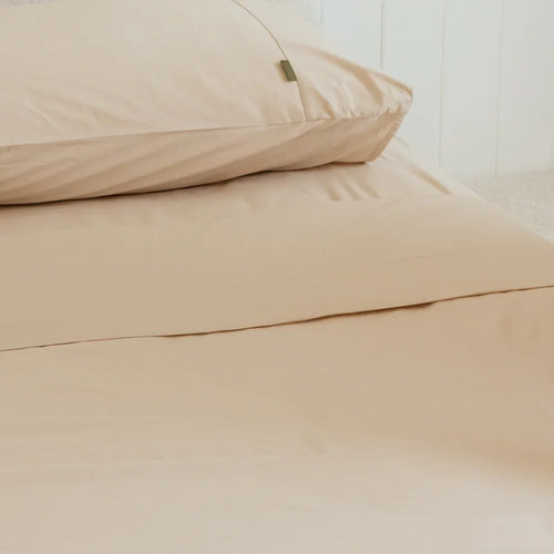 Sand pillowcases on queen bed with sand queen flat sheet from the 4th corner. 